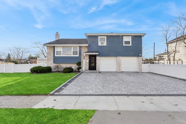 view of front of house featuring a front yard and a garage