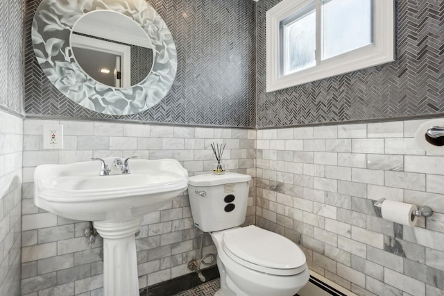 bathroom with tile walls and toilet