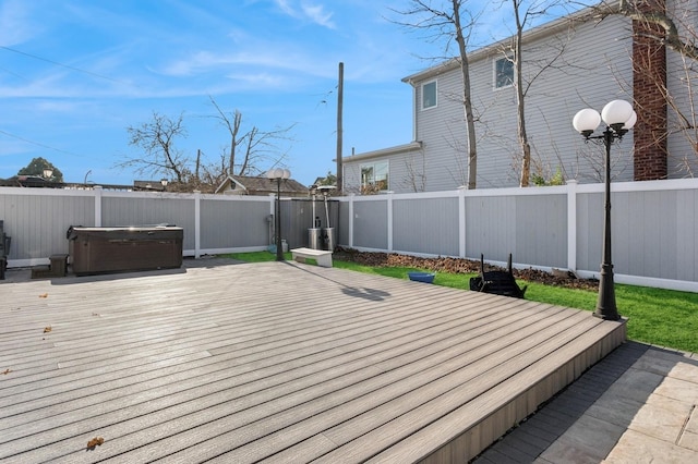 wooden deck featuring a hot tub