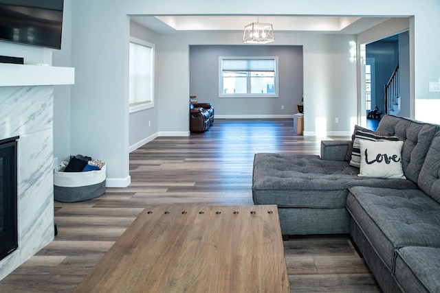 living room with dark hardwood / wood-style floors and a tile fireplace