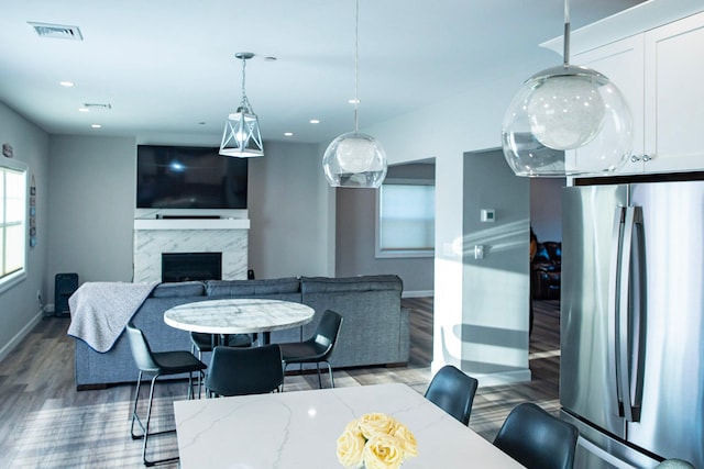 dining area with a fireplace and hardwood / wood-style floors