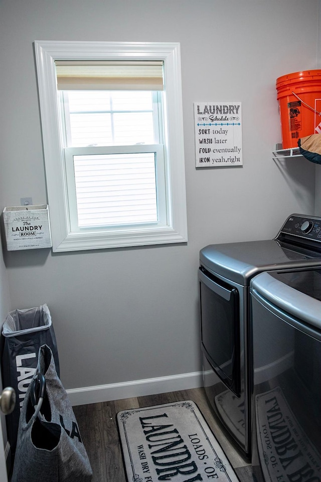 laundry area with washer and dryer and dark hardwood / wood-style floors