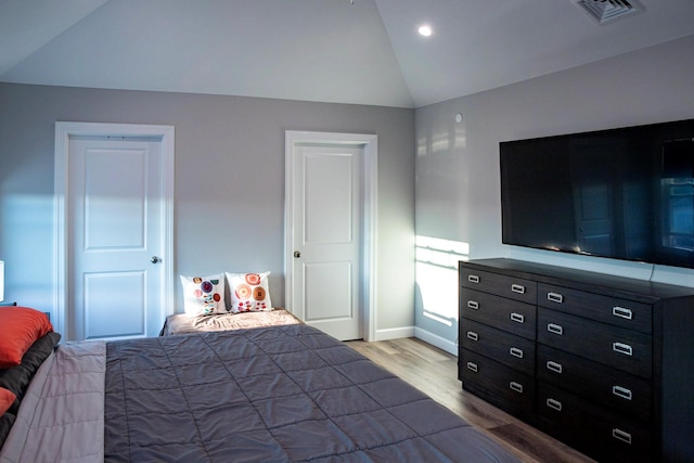 bedroom with wood-type flooring and lofted ceiling