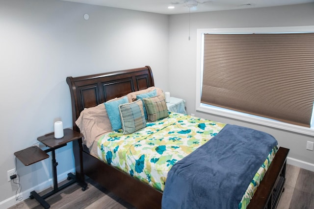 bedroom with ceiling fan and wood-type flooring