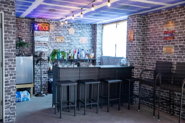 bar featuring concrete flooring and brick wall