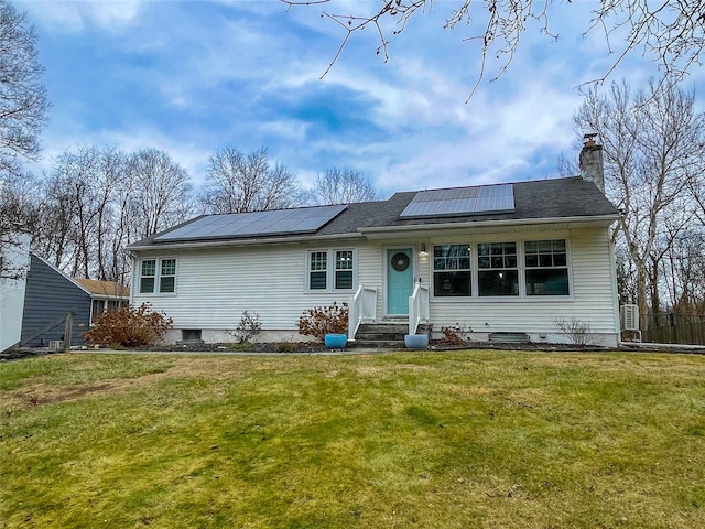 view of front of house featuring a front yard and solar panels