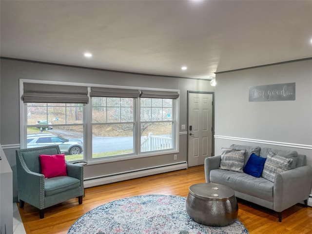 living room featuring hardwood / wood-style floors and a baseboard heating unit