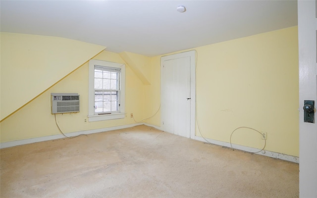 bonus room with vaulted ceiling, a wall mounted air conditioner, and carpet floors