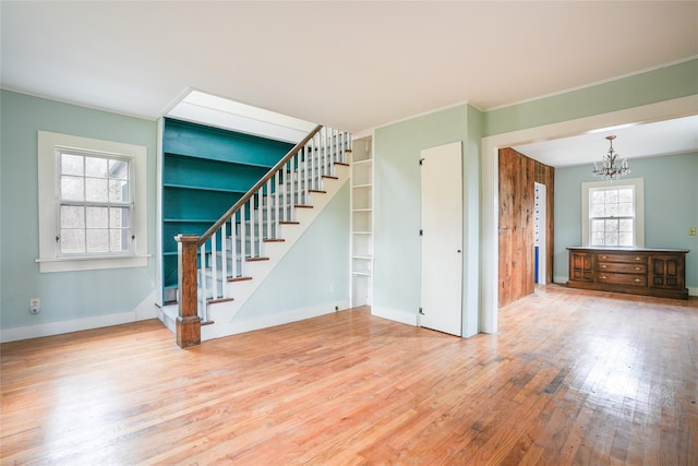 interior space with hardwood / wood-style floors and an inviting chandelier