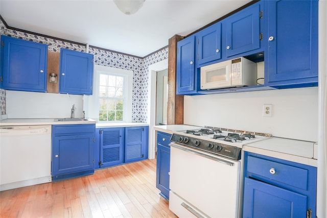 kitchen featuring blue cabinets, sink, white appliances, and light hardwood / wood-style flooring