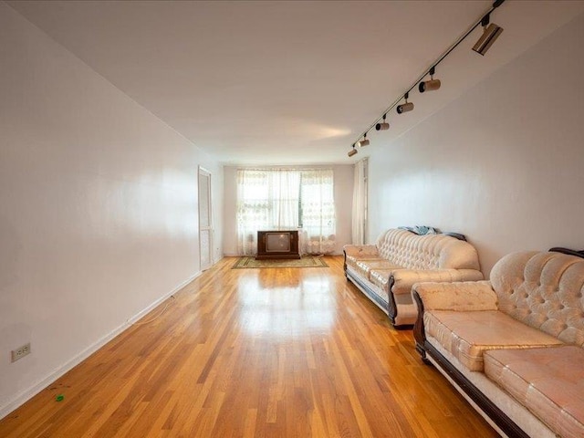 living room featuring light wood-type flooring and rail lighting