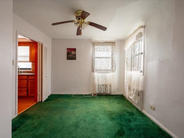 empty room featuring ceiling fan, carpet, and a healthy amount of sunlight