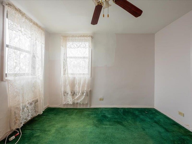 spare room featuring carpet and ceiling fan