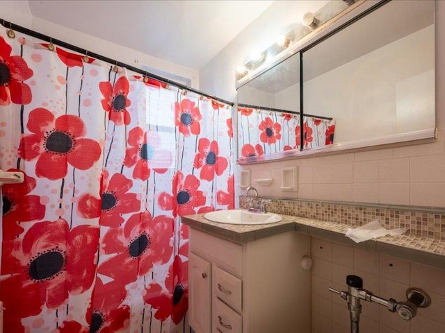 bathroom with tasteful backsplash and vanity