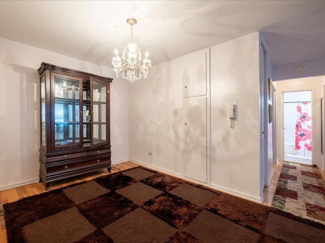 unfurnished dining area with hardwood / wood-style flooring and an inviting chandelier