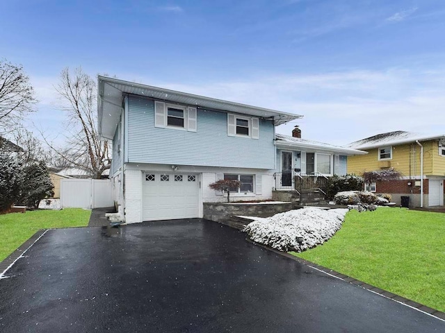 tri-level home with a front yard and a garage