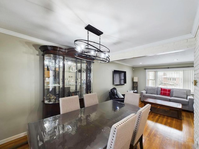 dining area featuring a chandelier, hardwood / wood-style floors, and crown molding