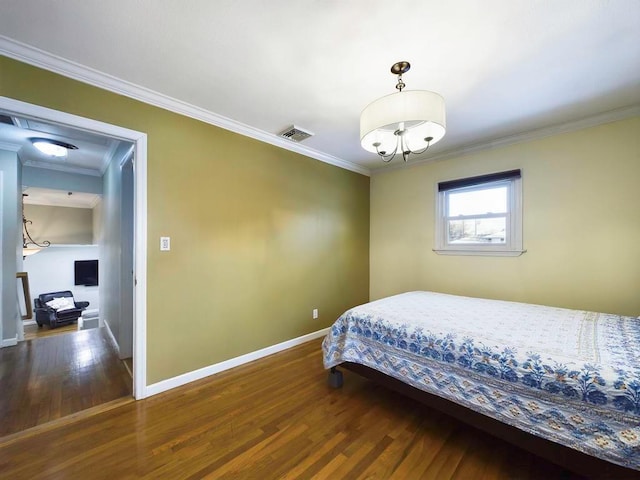 bedroom with dark hardwood / wood-style flooring and ornamental molding