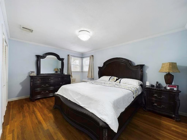 bedroom featuring crown molding, a closet, and dark wood-type flooring