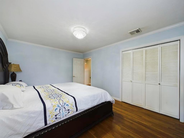 bedroom with dark hardwood / wood-style floors, a closet, and ornamental molding