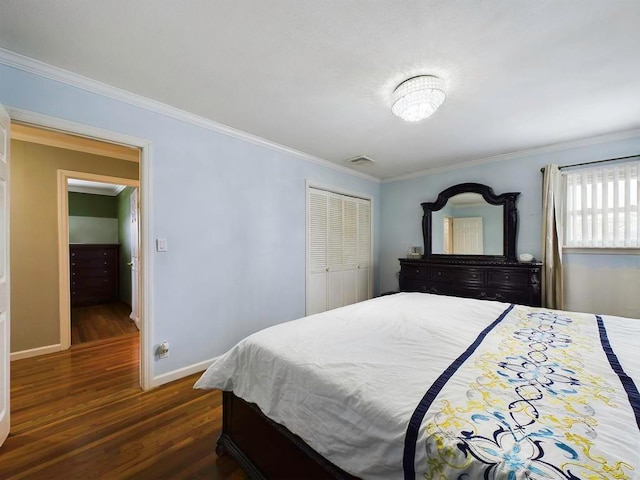 bedroom featuring dark hardwood / wood-style flooring, a closet, and ornamental molding