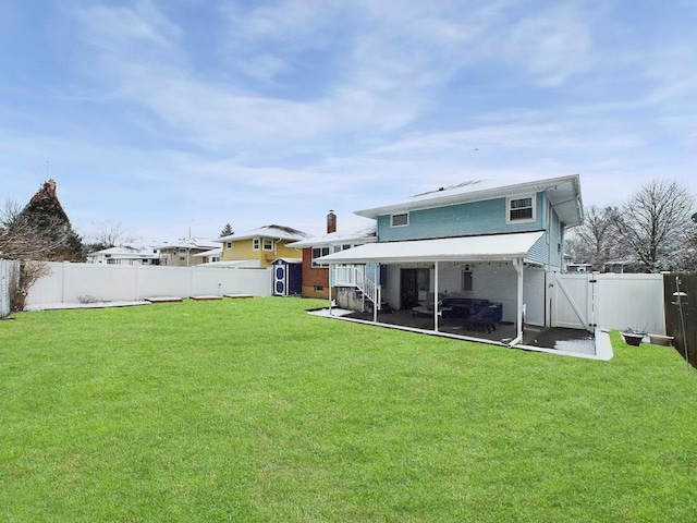 back of house featuring a lawn