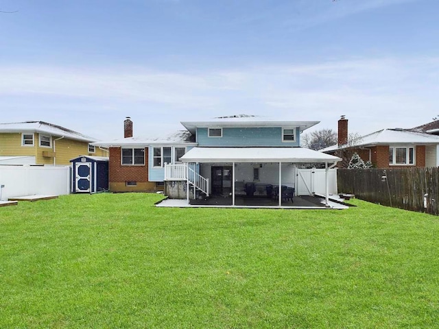 back of property with a yard, a storage shed, and a sunroom