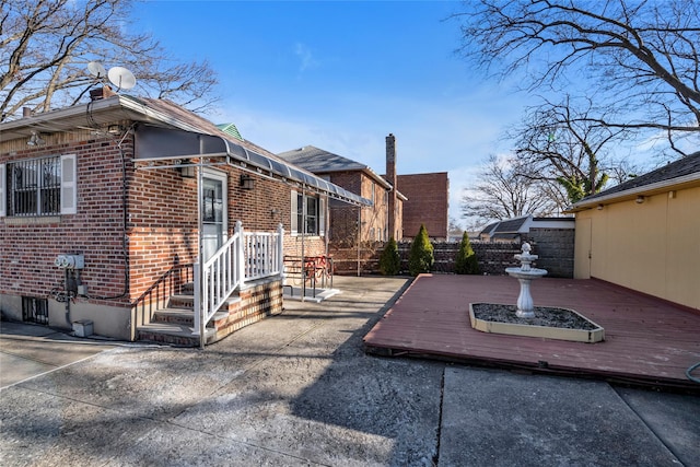 view of side of home featuring a wooden deck