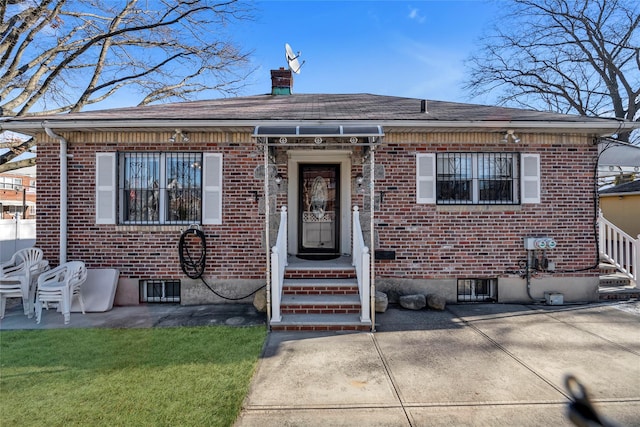 bungalow with a patio area and a front lawn