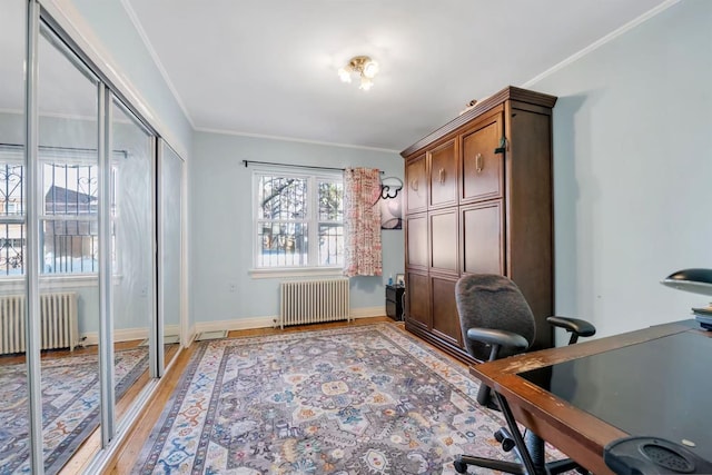 office with radiator heating unit, hardwood / wood-style floors, and ornamental molding