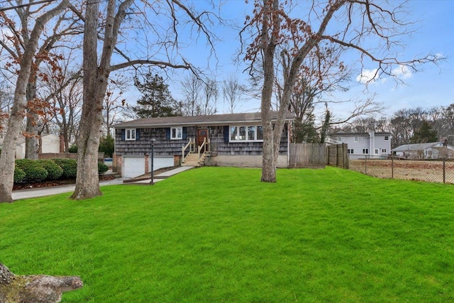 ranch-style home featuring a garage and a front lawn