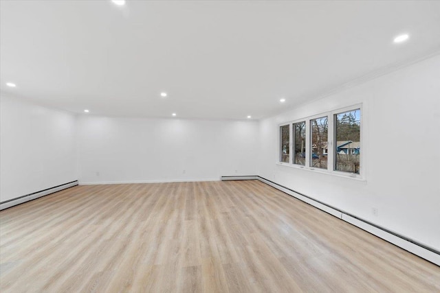 unfurnished room featuring light wood-type flooring and a baseboard radiator