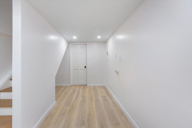 hallway with light hardwood / wood-style floors