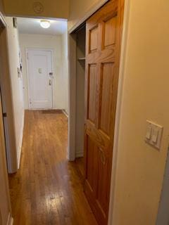 hall with hardwood / wood-style flooring