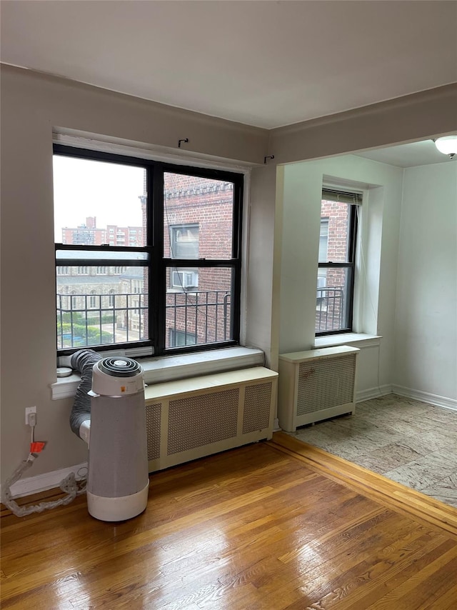 unfurnished room featuring light hardwood / wood-style flooring and radiator