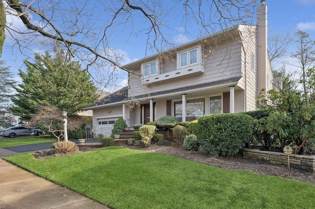 view of front of home with a front yard and a garage