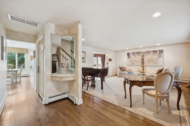 dining space featuring hardwood / wood-style floors and a baseboard radiator