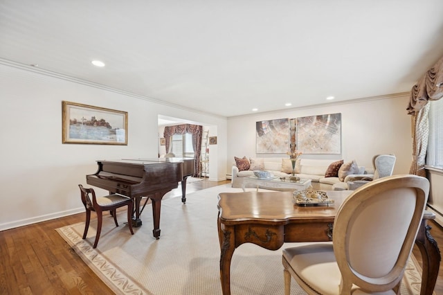 interior space with hardwood / wood-style floors, a baseboard heating unit, and crown molding