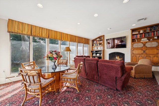 living room with a fireplace and built in shelves