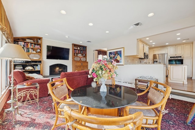 tiled dining area with built in features and a brick fireplace