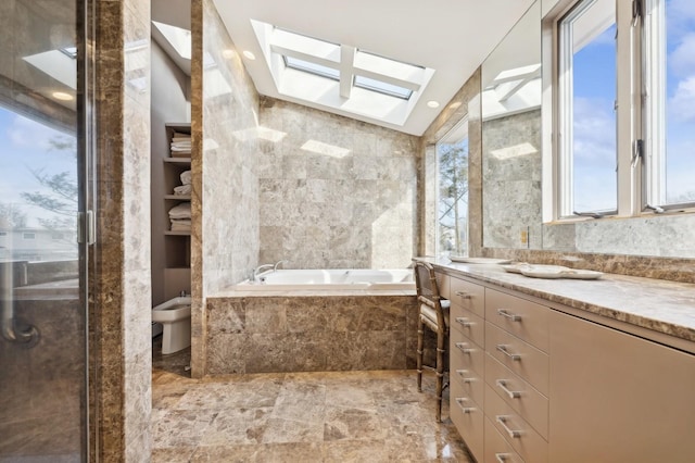 bathroom featuring separate shower and tub, lofted ceiling with skylight, a bidet, vanity, and tile walls