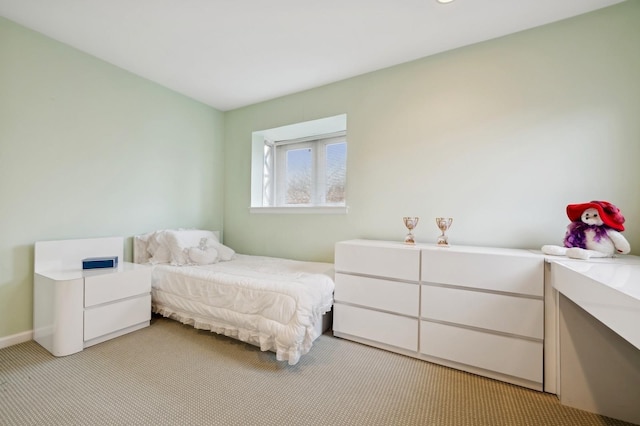 bedroom featuring light carpet