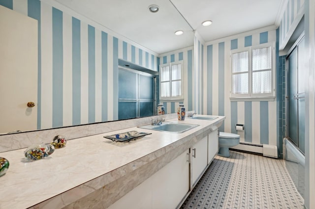 full bathroom featuring shower / bath combination with glass door, toilet, baseboard heating, and crown molding