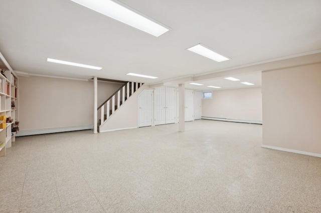 basement with crown molding and a baseboard radiator