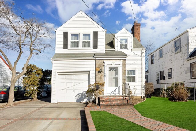 view of front of property featuring a garage and a front yard