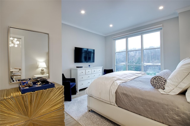 bedroom with ornamental molding and light hardwood / wood-style flooring