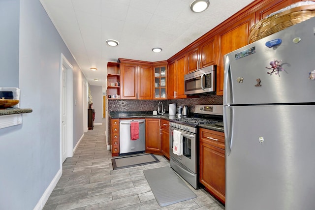 kitchen featuring appliances with stainless steel finishes, tasteful backsplash, and sink