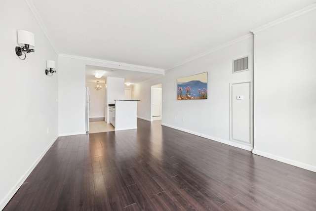 unfurnished living room with a chandelier, crown molding, and dark wood-type flooring