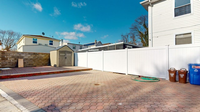 view of yard featuring a storage unit and a patio area