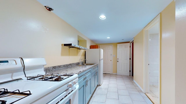 kitchen with sink, white appliances, and light tile patterned flooring